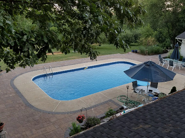 backyard view of pool, patio, and firepit