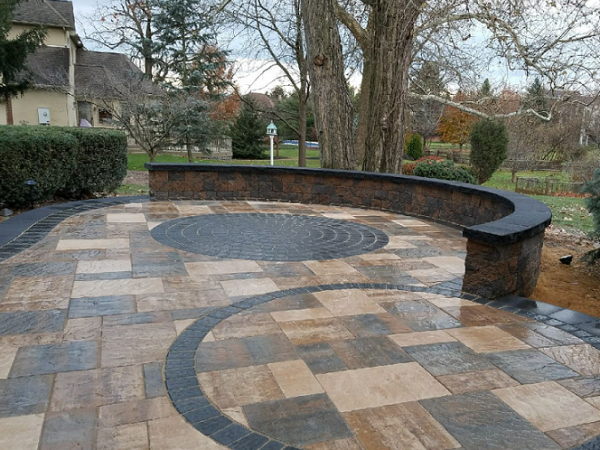 backyard multi patio design with colored pavers