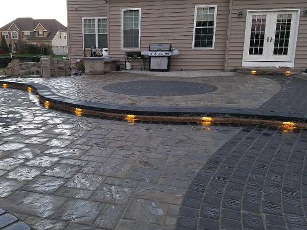 back patio with custom lighting under walls and circle patio 