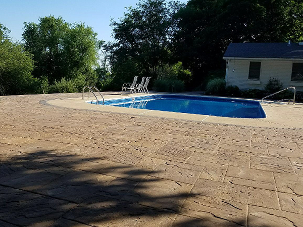 pool with custom hardscape, firepit, and hottub in backyard