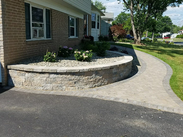 outdoor walkway with retaining walll next to driveway