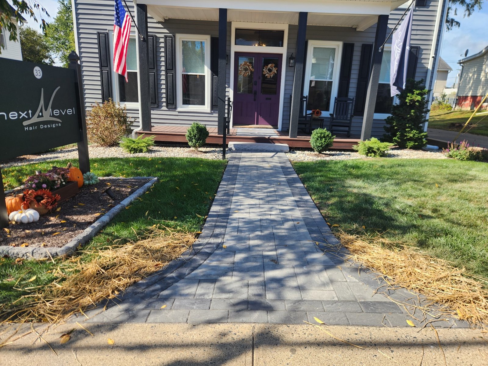 paver patio walkway surrounded by landscape