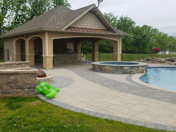 paver patio surrounding pool